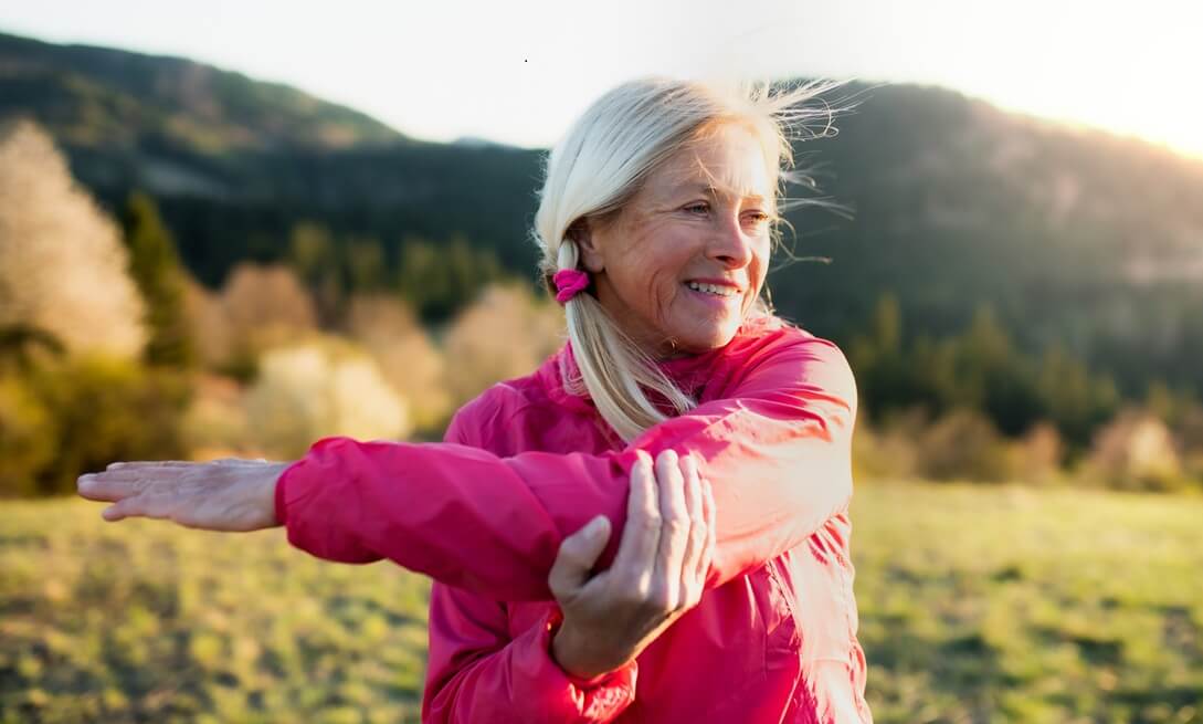 senior woman doing exercise outdoors