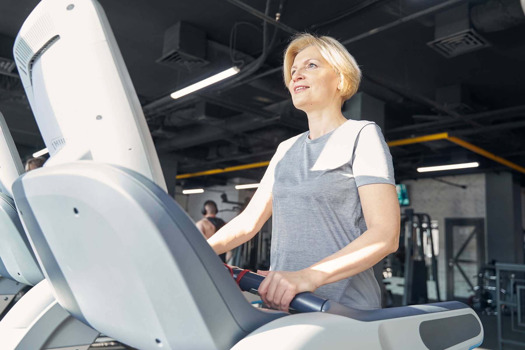 woman doing cardio on a treadmill in a gym