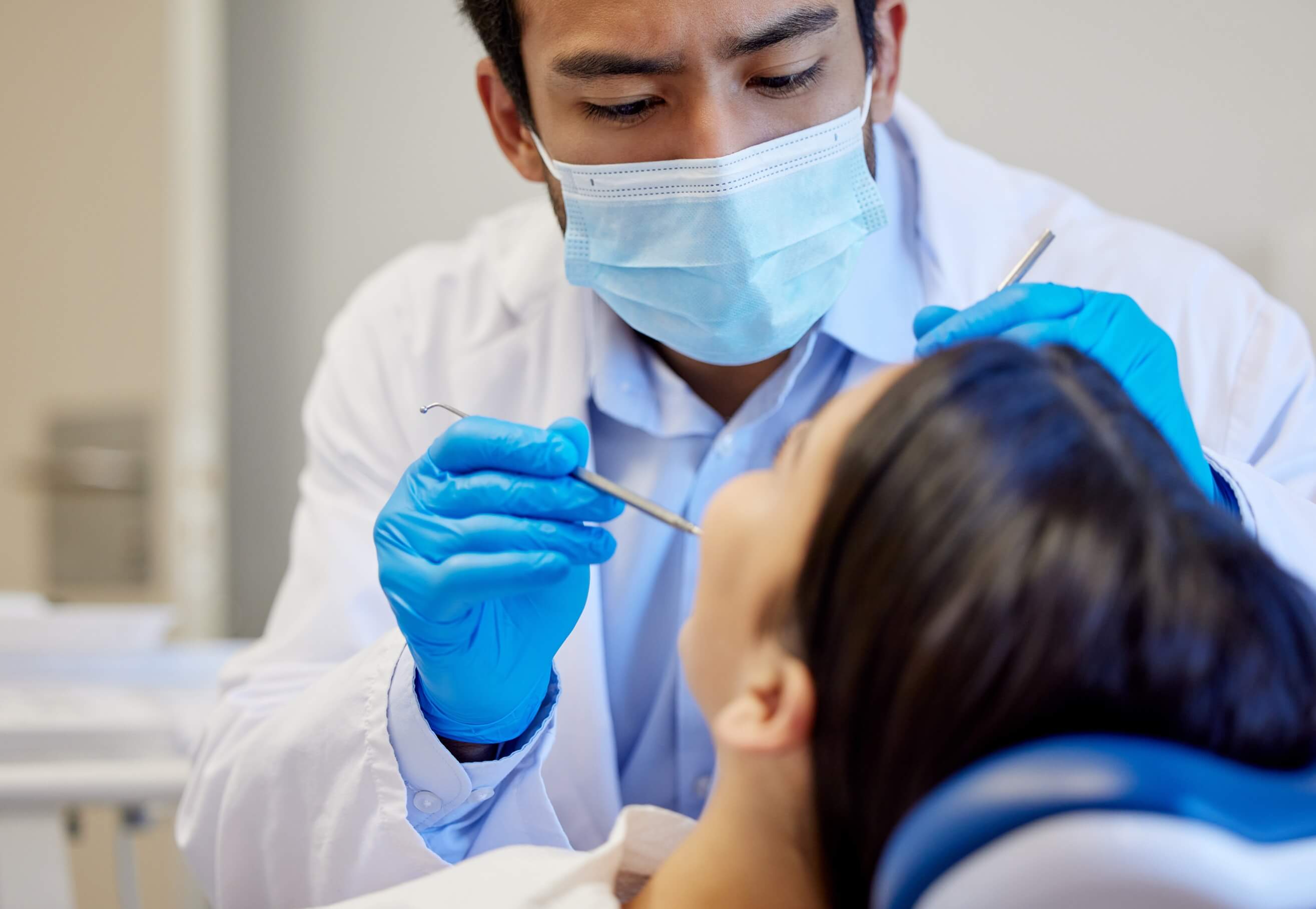 dentist with patient in exam room