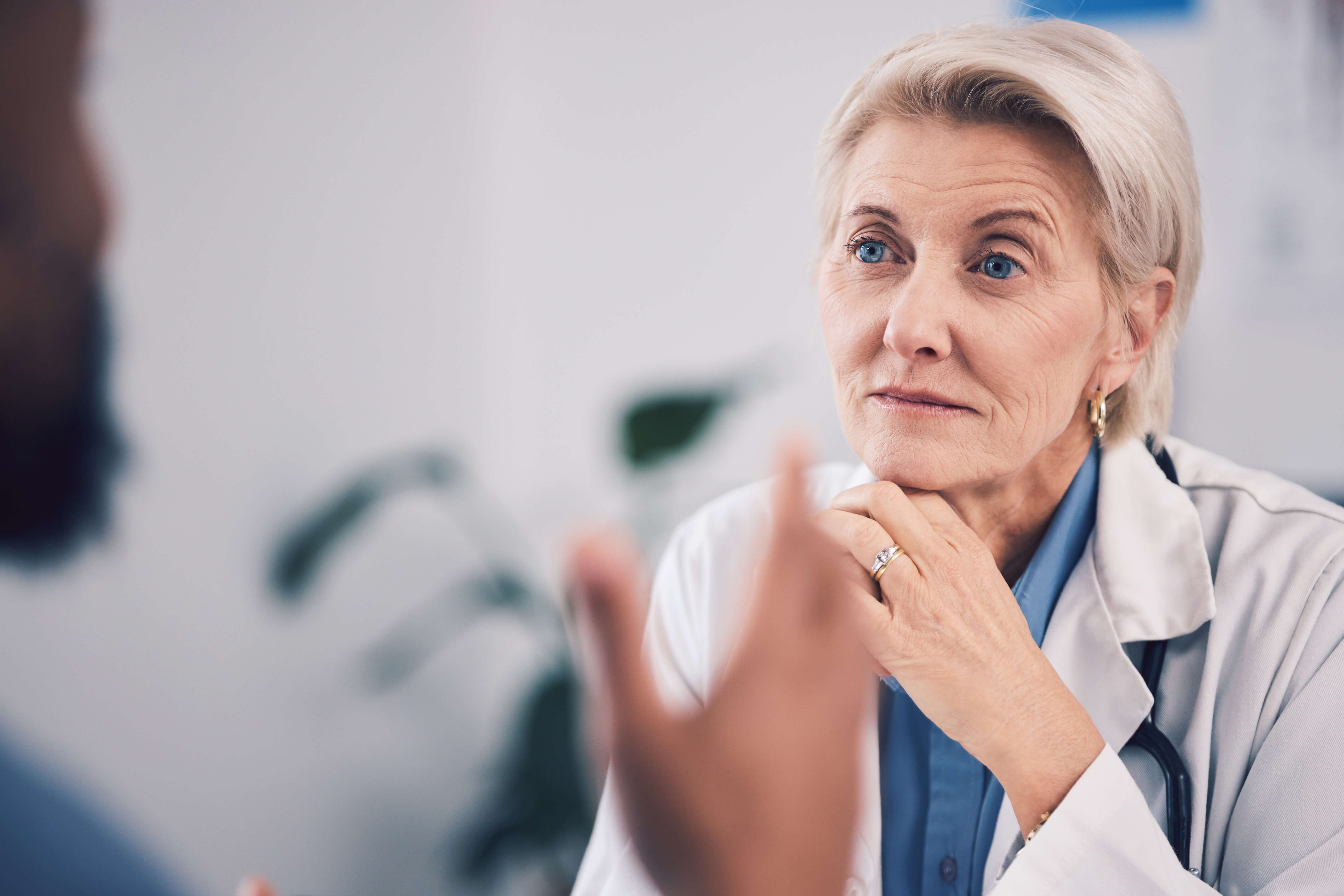 face of woman doctor and listening in consultation