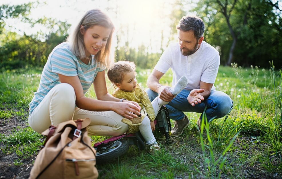 family with small daughter outdoors in nature