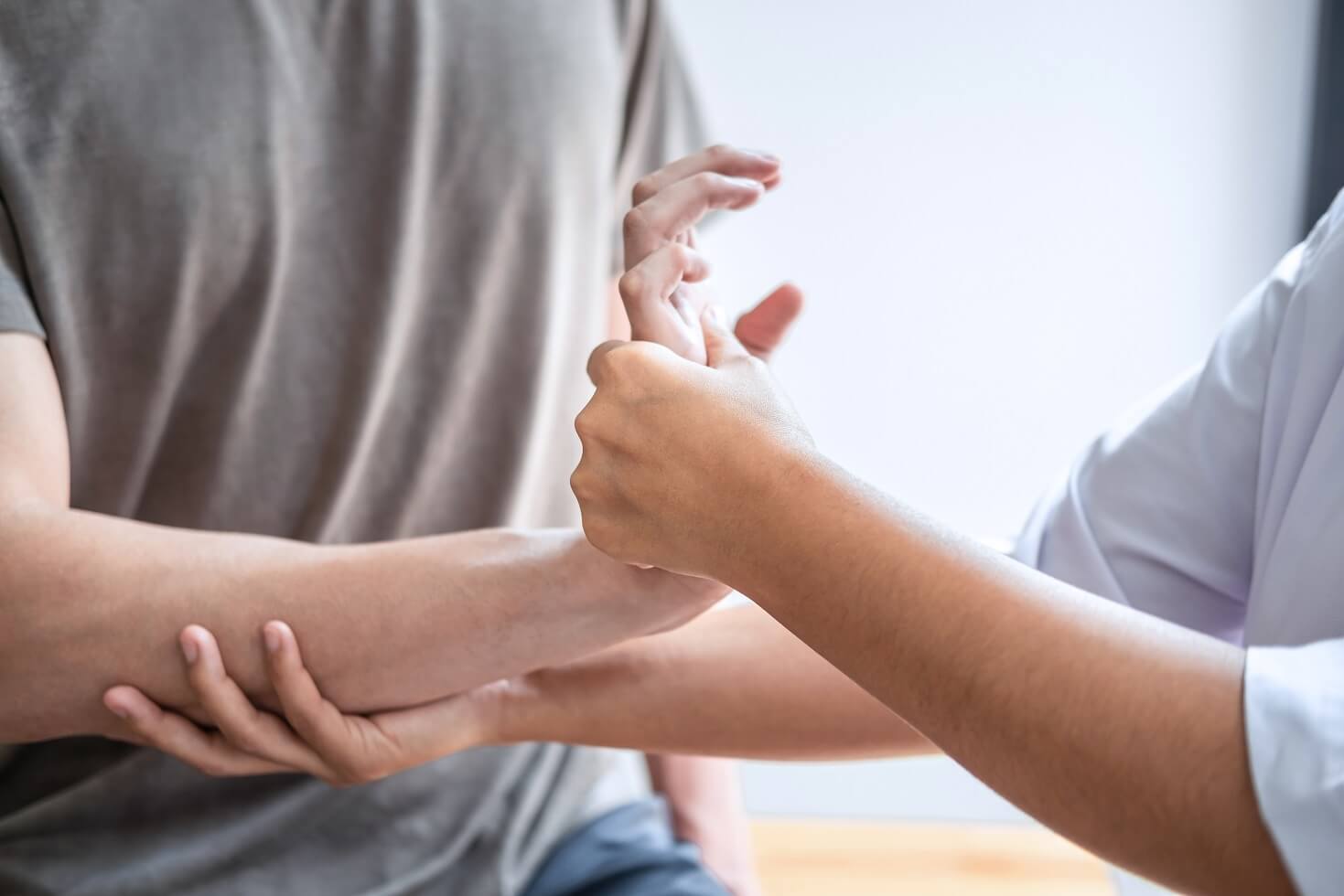 physiotherapist examining wrist for MSK conditions