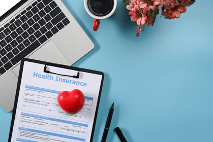 health insurance form on a desk with a heart