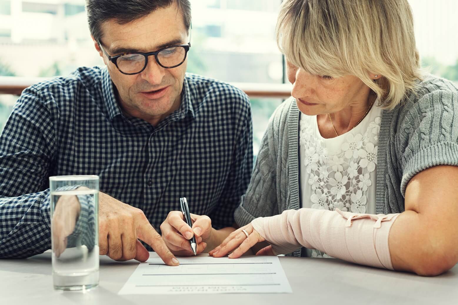 mature-man-and-woman-signing-paperwork-indoors-2026-09-15-20-17-43-utc (1)