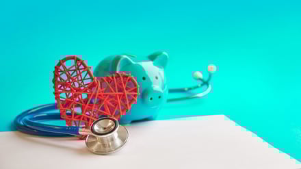 Stethoscope, heart and piggy bank in a healthcare setting