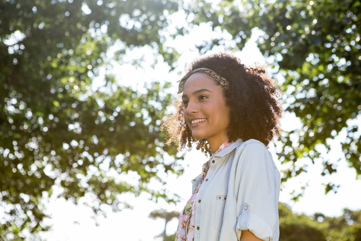 woman smiling in a sunny park