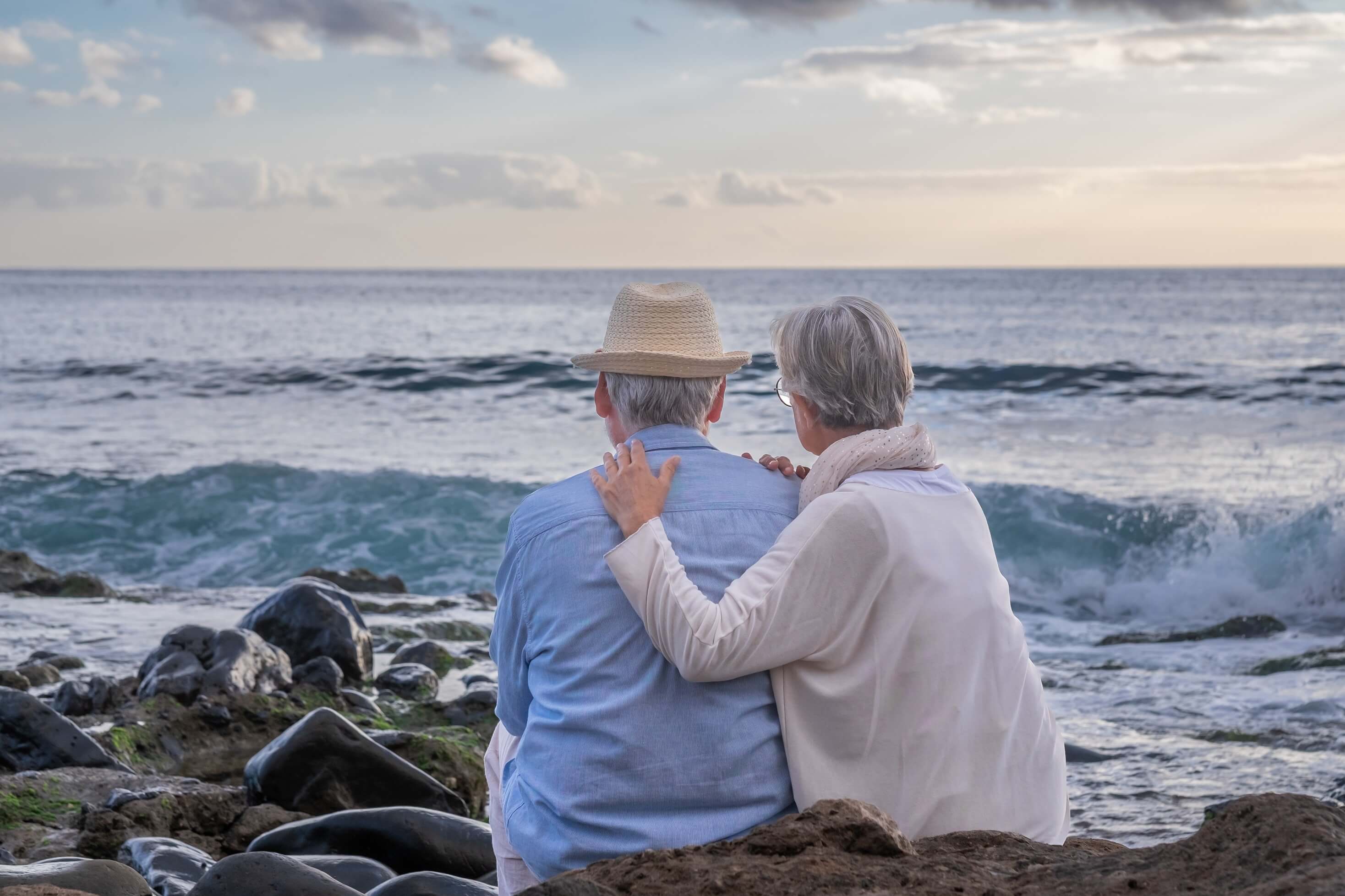 rear view of a couple relaxing at the beach