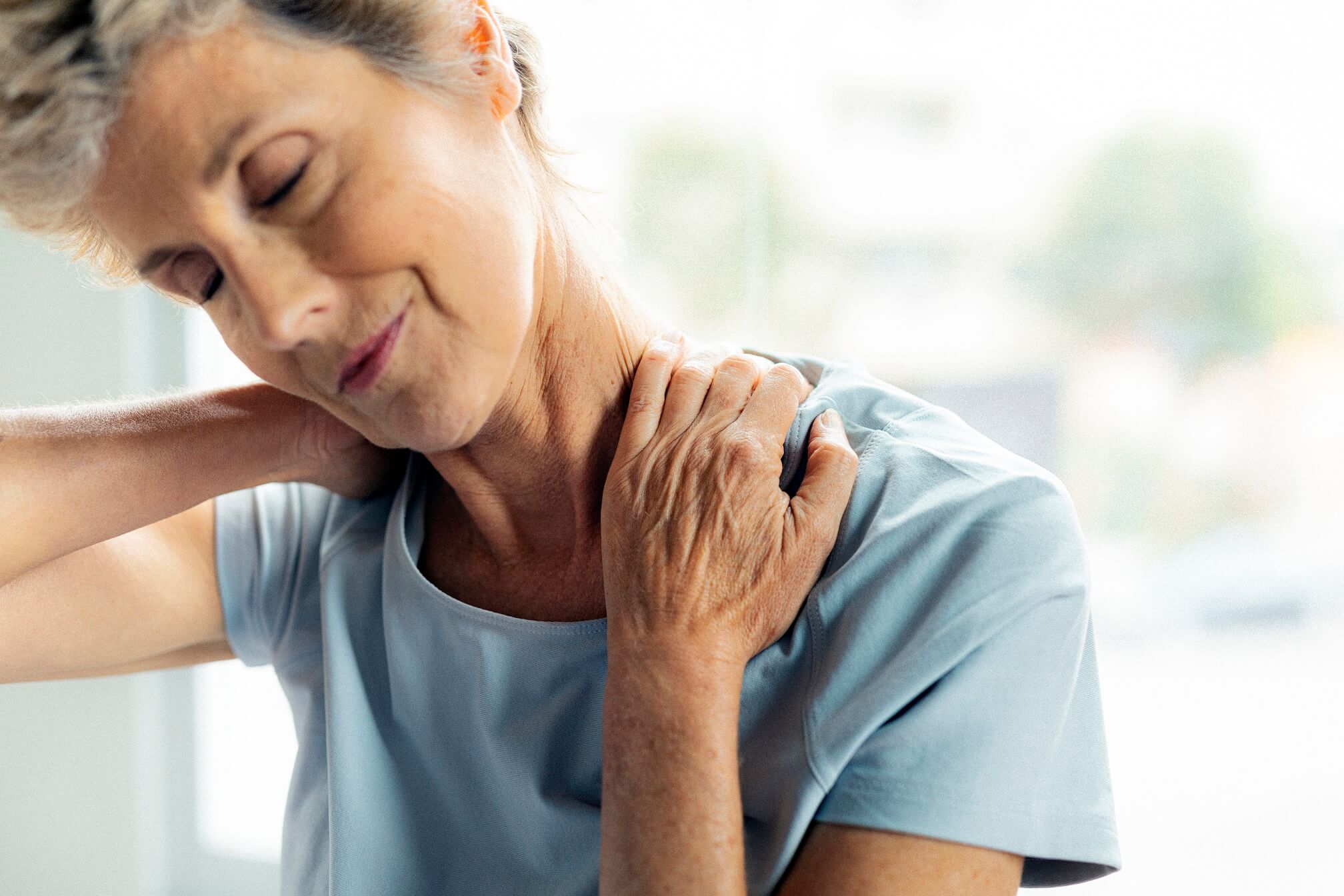 senior lady holding her neck