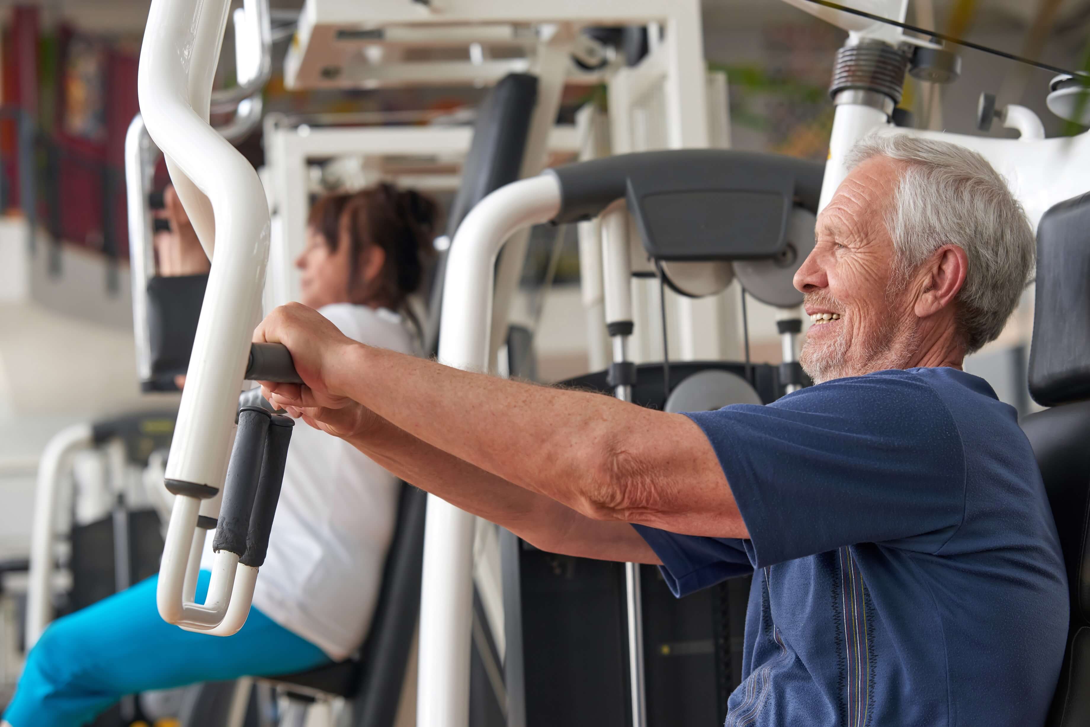 senior man training at the gym side view