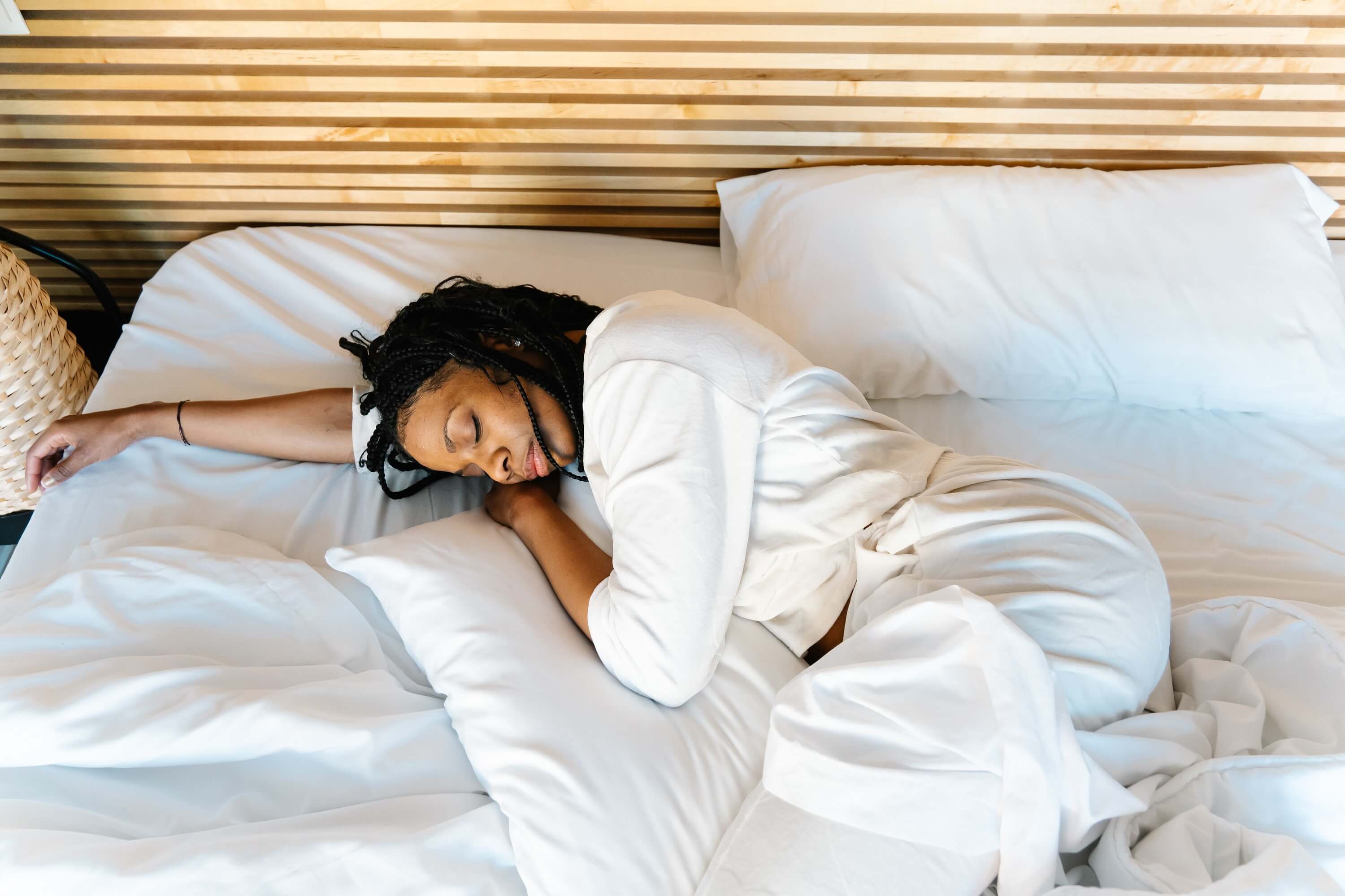 a woman sleeping peacefully/relaxing in a bed