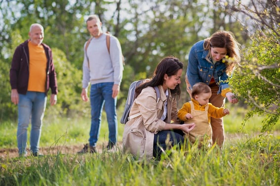 small toddler with parents and grandparents on a walk