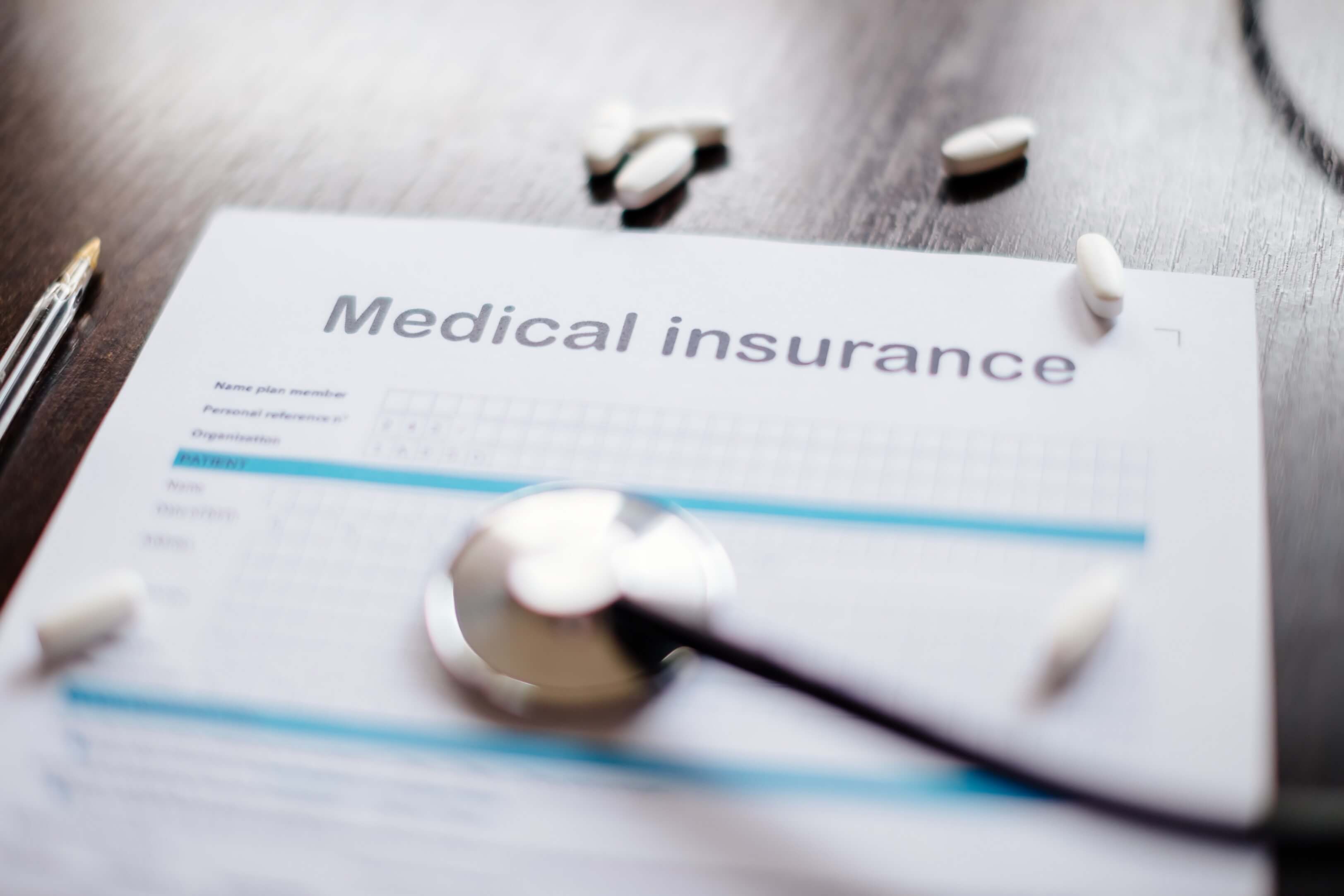 Medical insurance form with a stethoscope on a table