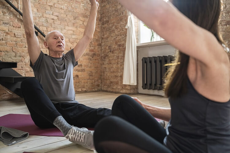 two senior people during a yoga session