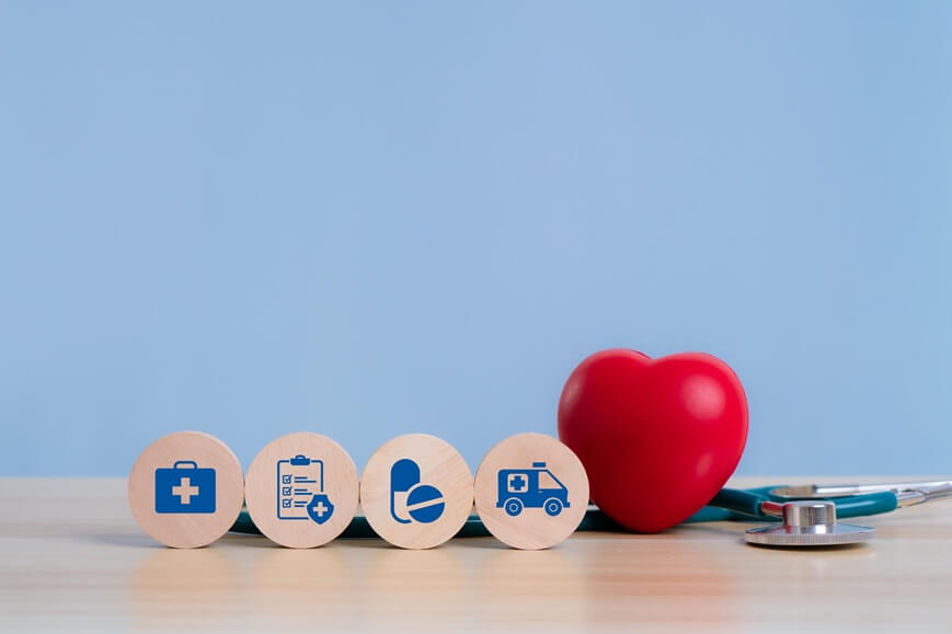 wooden block with health care insurance and medical equipment