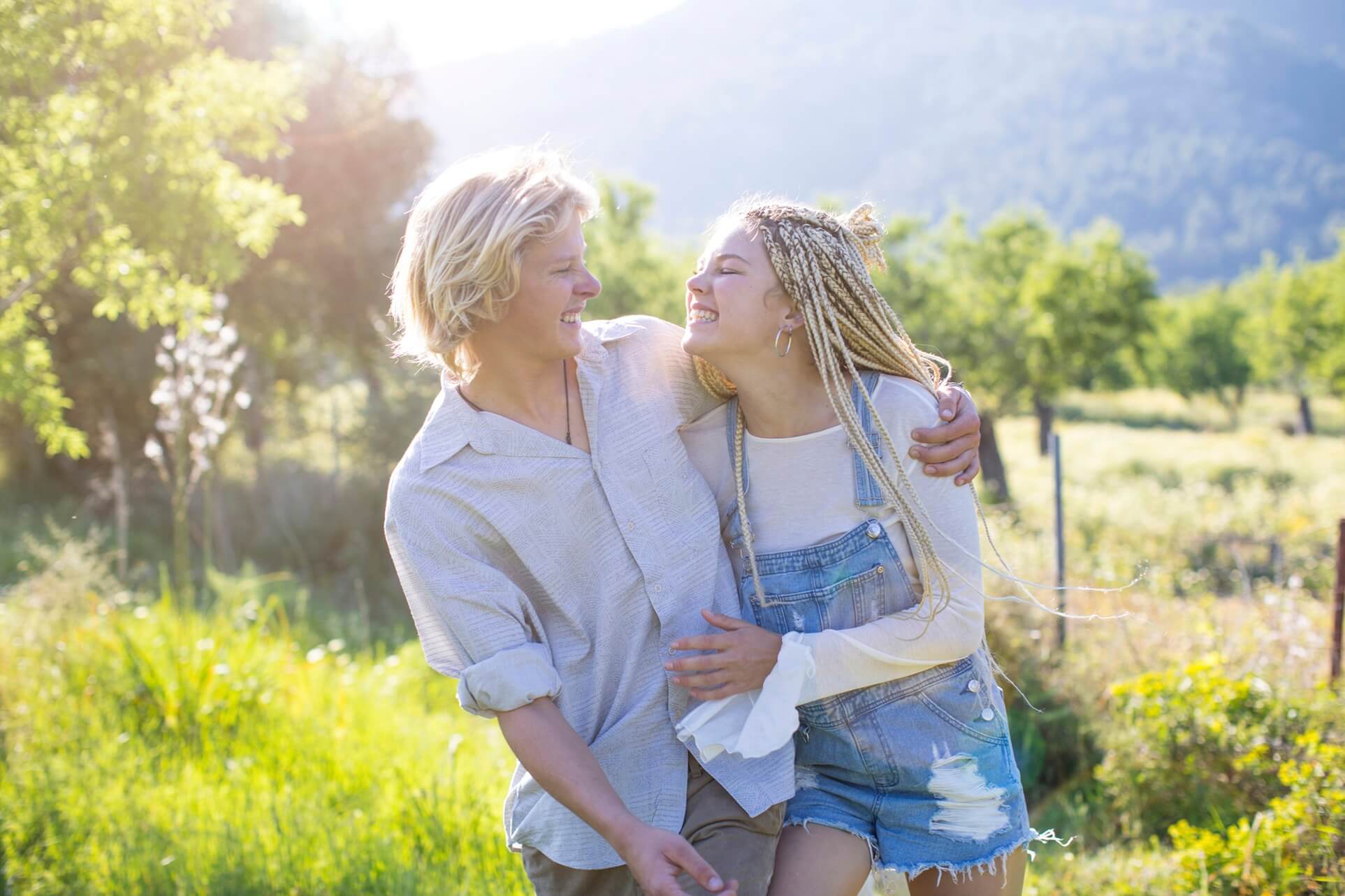young couple laughing whilst walking outdoors