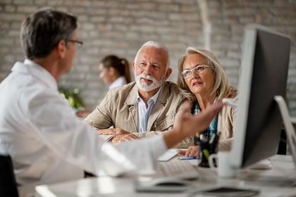Mature couple having a meeting with senior health insurance expert