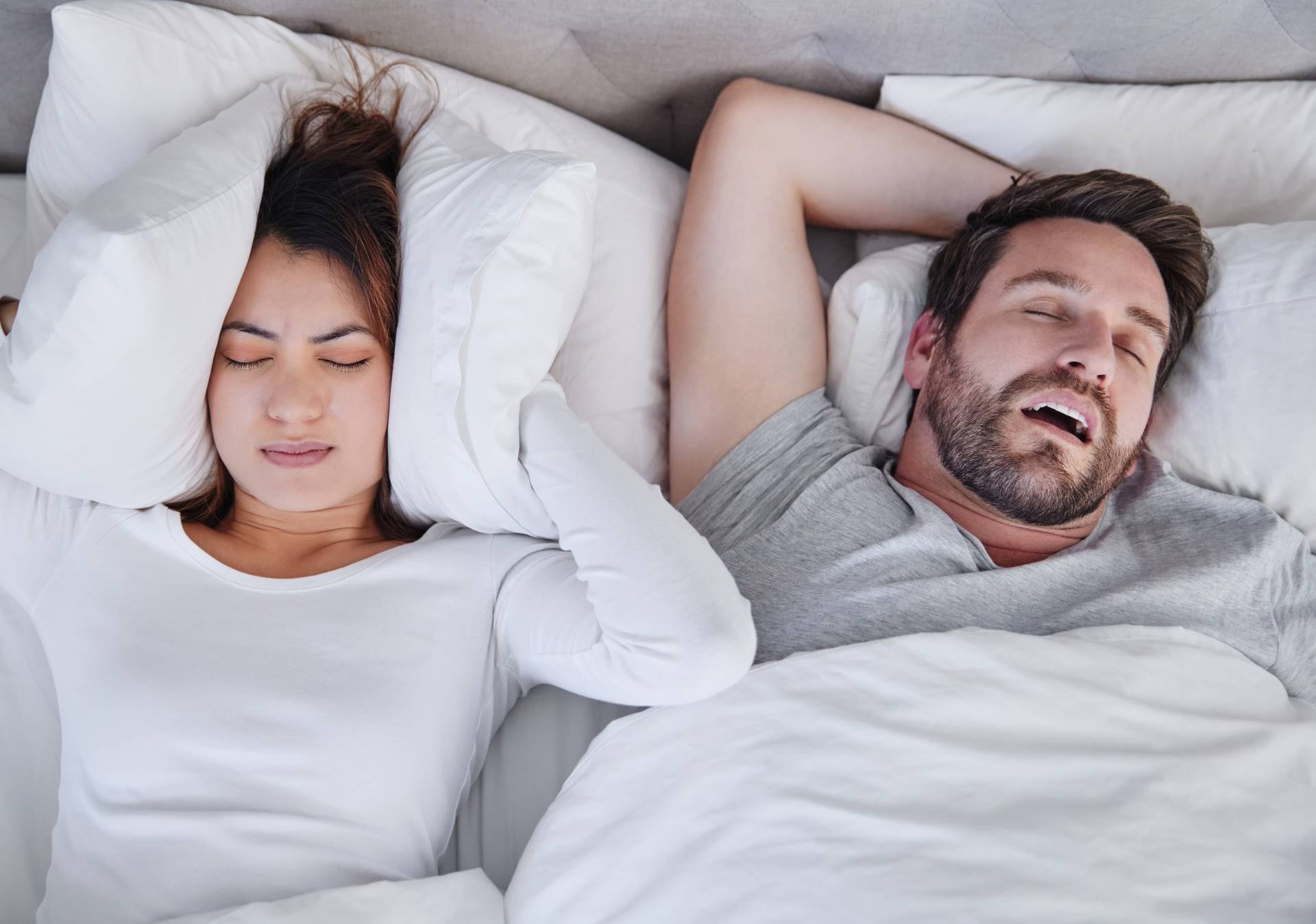 Woman struggling to sleep with her boyfriends snoring