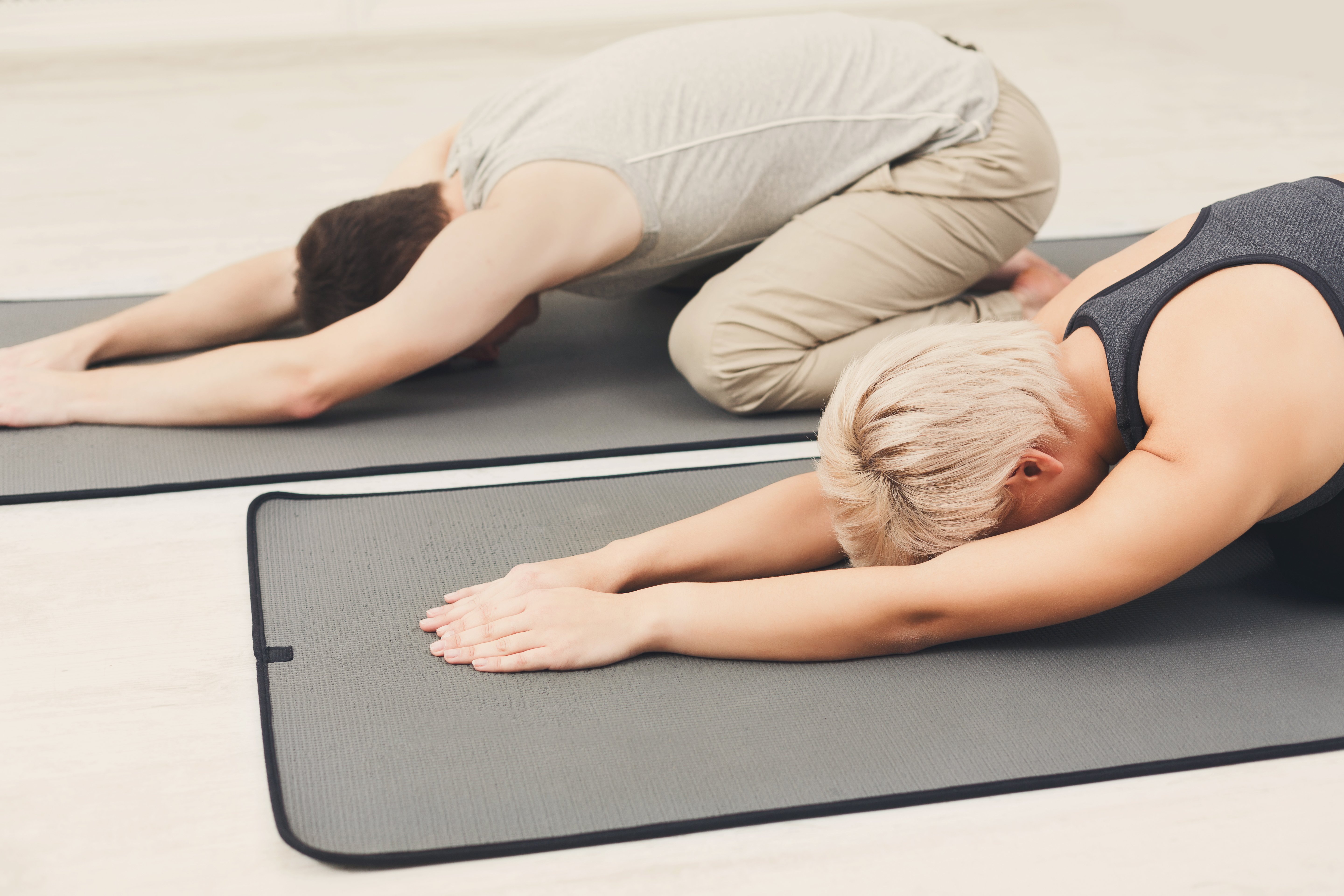 couple-training-yoga-in-child-s-pose-2022-12-16-07-10-20-utc
