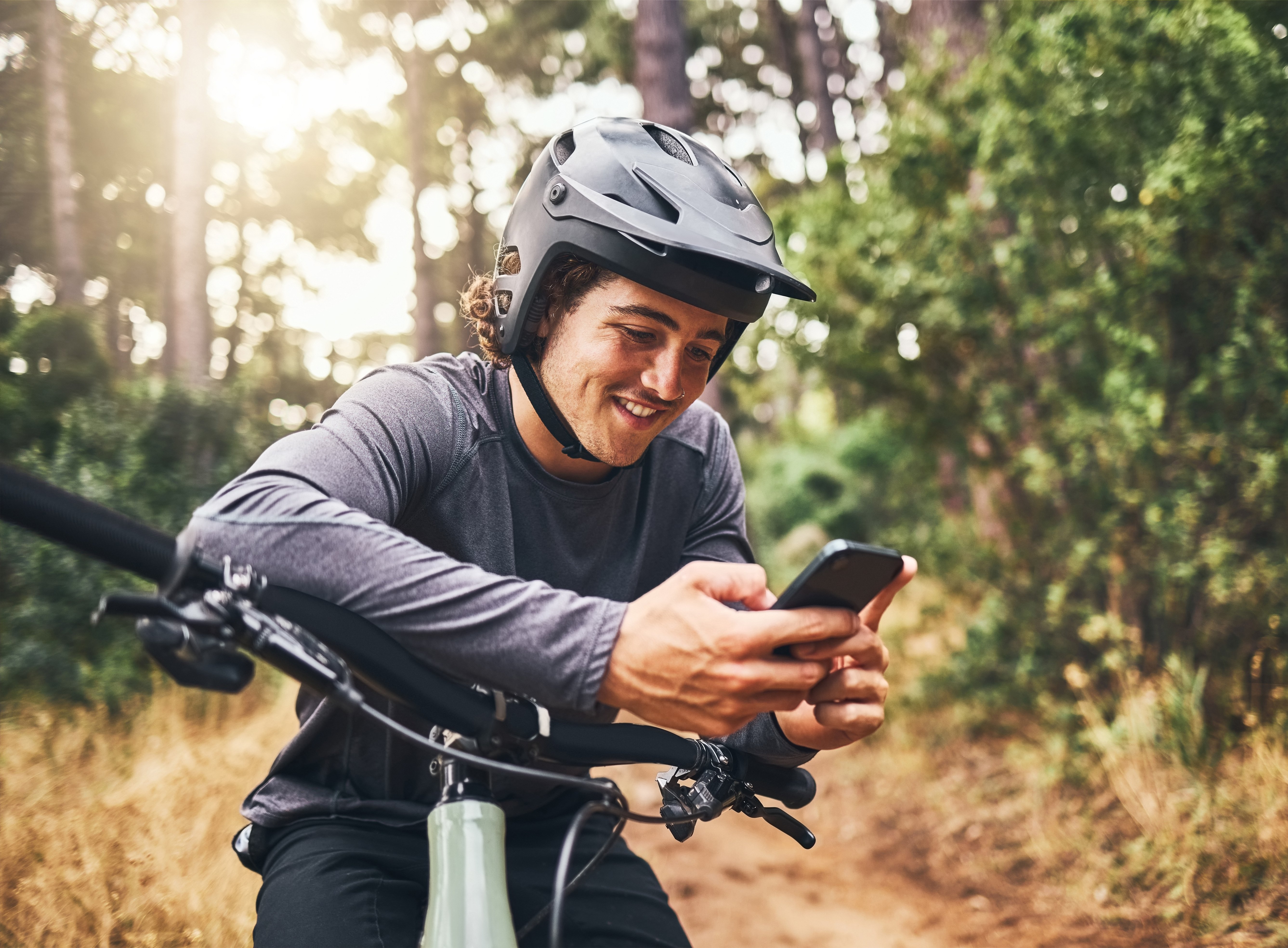 cycling-man-in-forest-phone-gps-and-map-direction-2022-12-14-23-23-10-utc