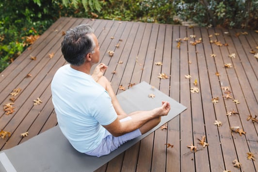 happy-senior-caucasian-man-practicing-yoga-medita-private-health-insurance