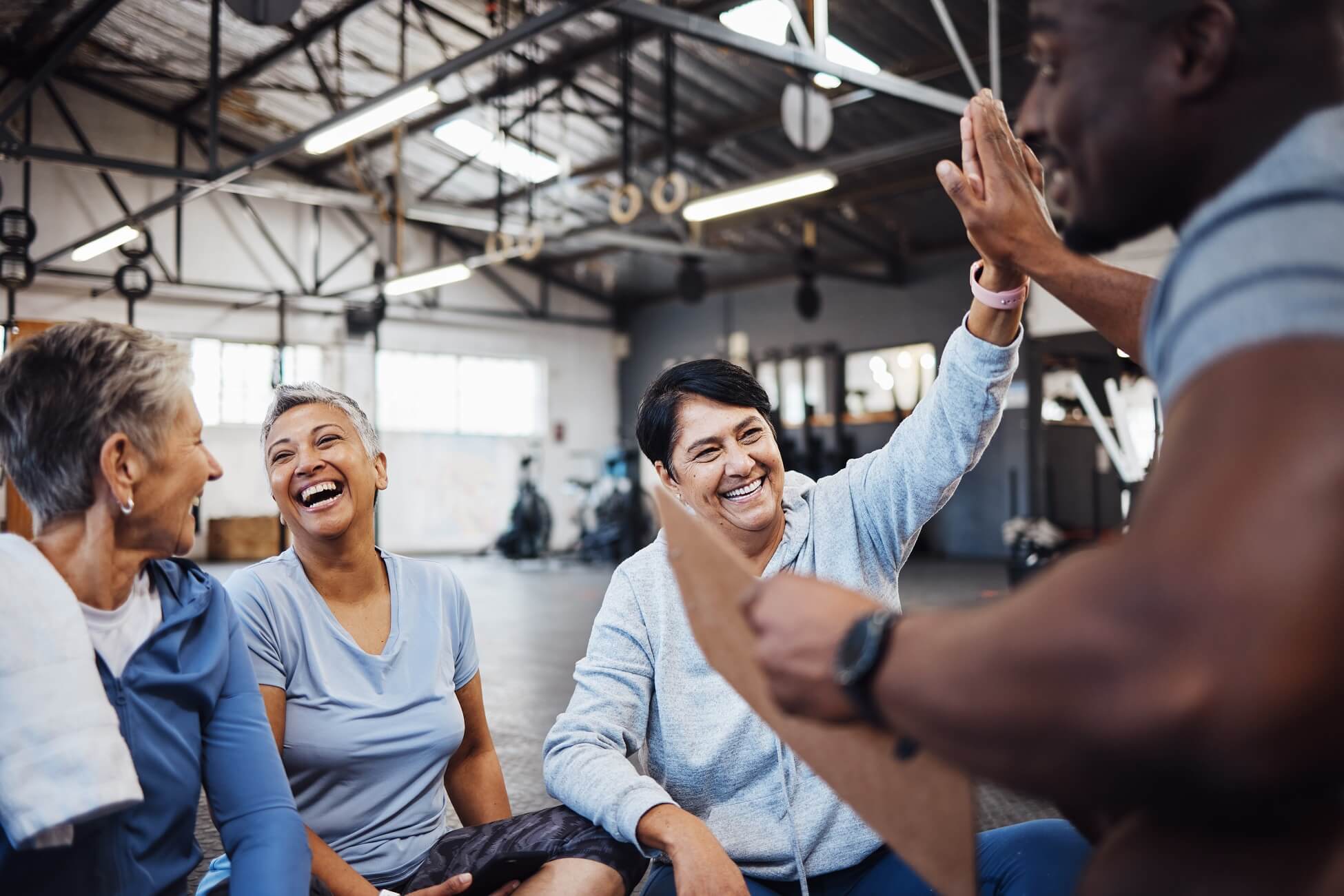 Group of senior women high fiving instructor