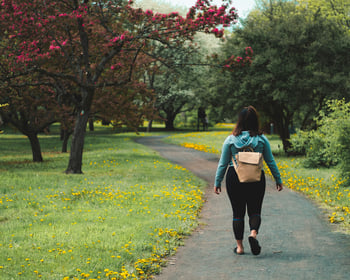 Girl walking in a green space
