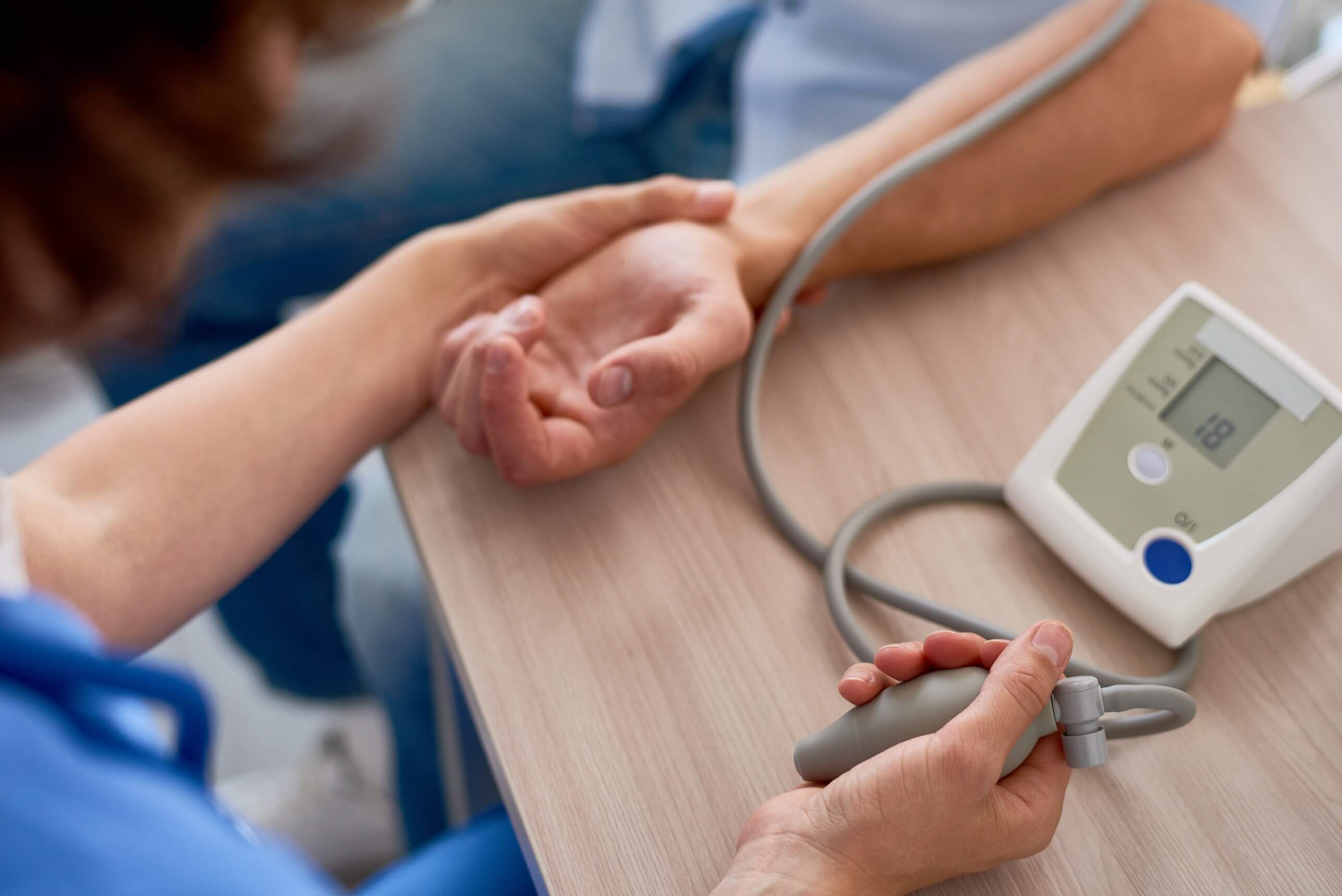 A nurse taking a patients blood pressure