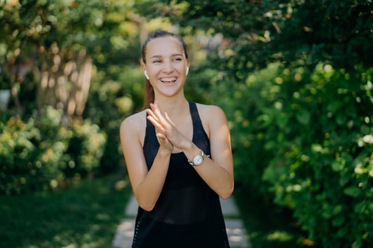 overjoyed-woman-keeps-hands-together-laughs-happil-private-health-insurance