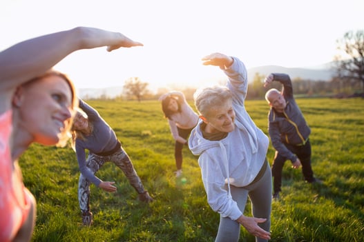 seniors-with-sport-instructor-doing-exercise-outdo-private-medical-insurance