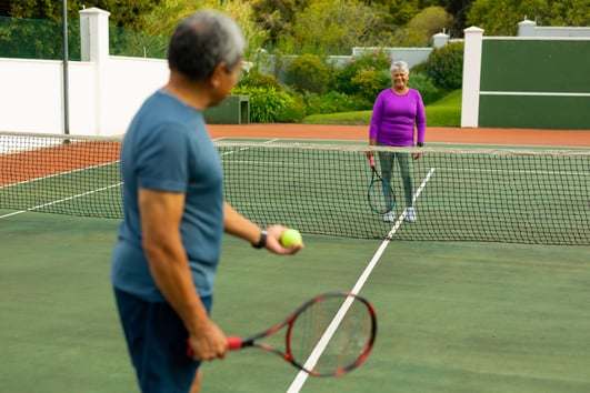 smiling-biracial-senior-woman-playing-tennis-with-2022-05-15-23-02-24-utc
