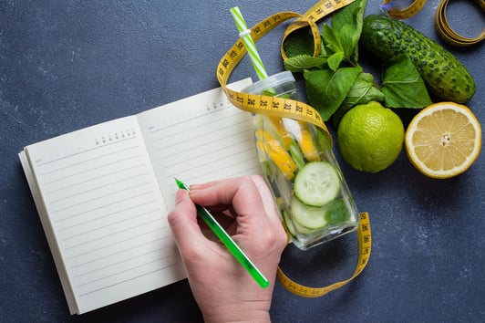 woman-writing-nutrition-plan-diet-menu-and-fitness-private-health-insurance